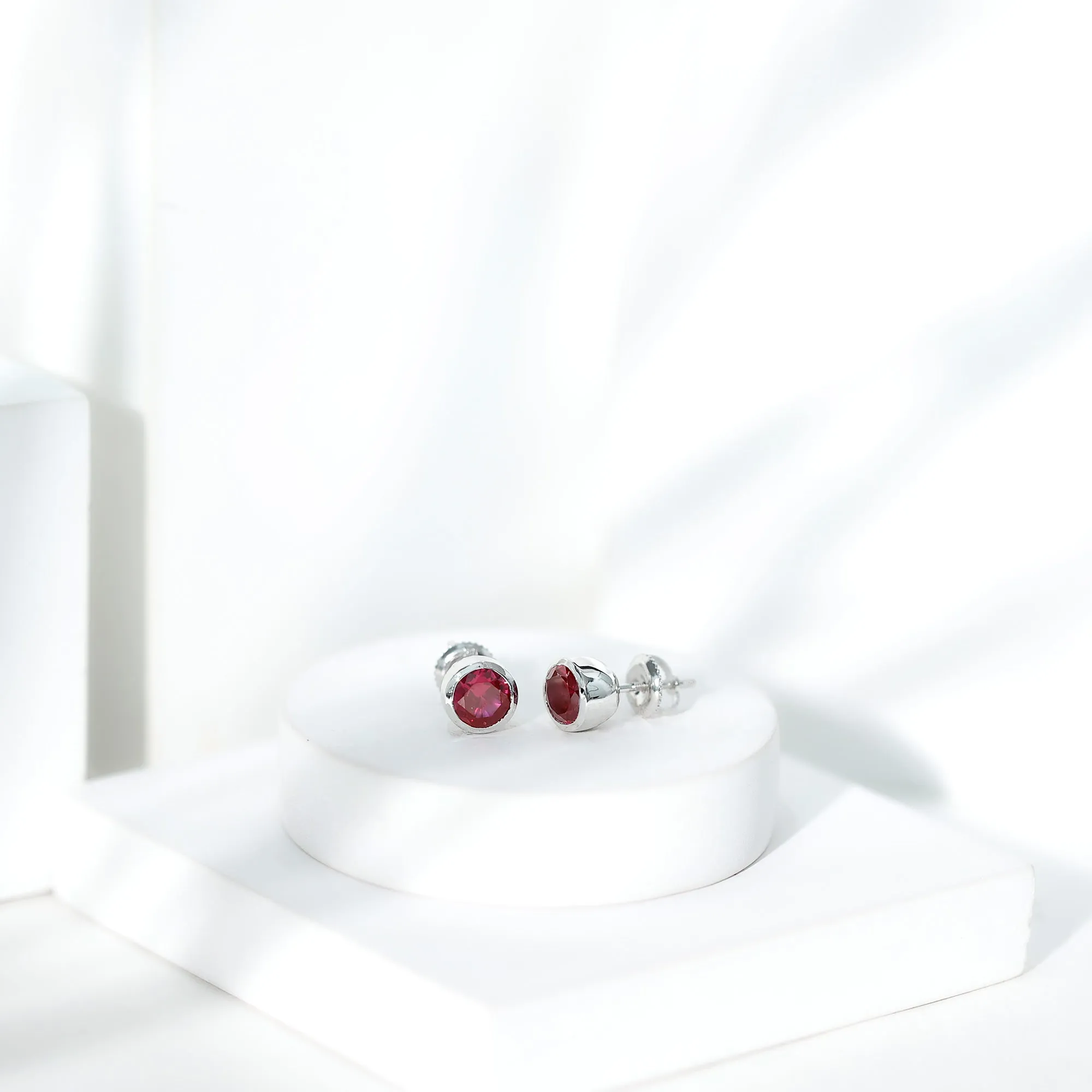 Created Ruby Solitaire Stud Earrings in Bezel Setting