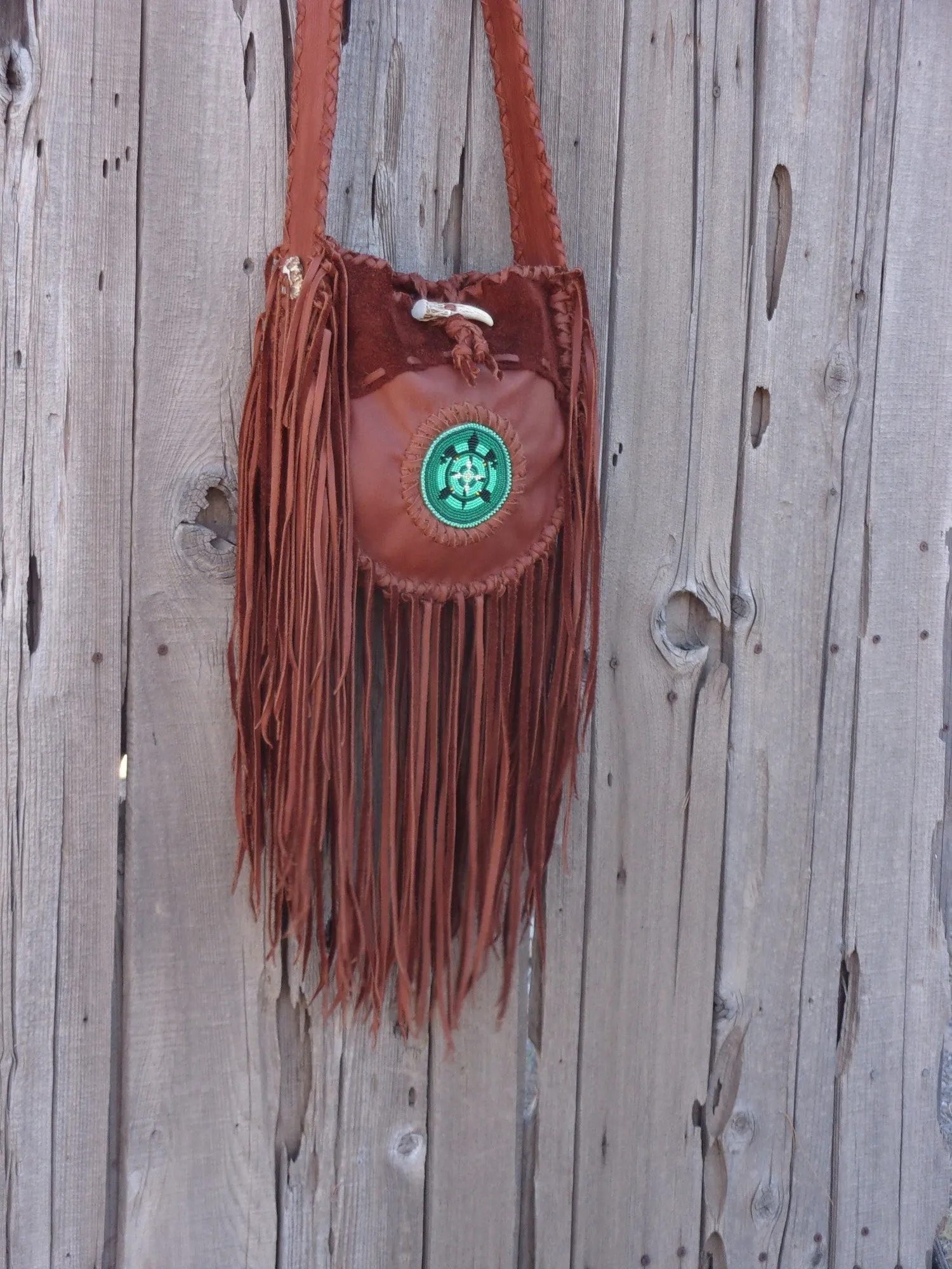 Fringed leather tote with beaded turtle