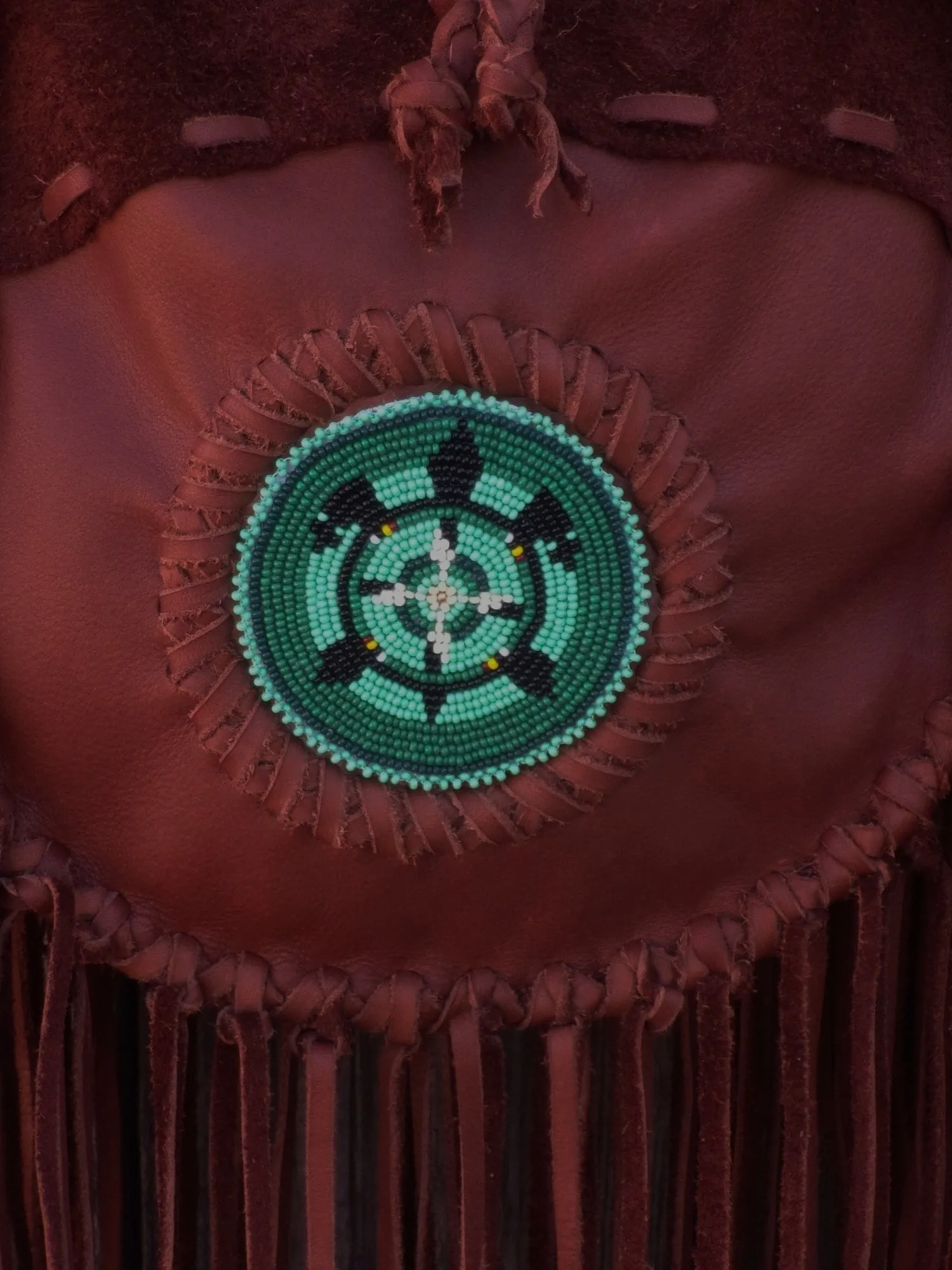 Fringed leather tote with beaded turtle